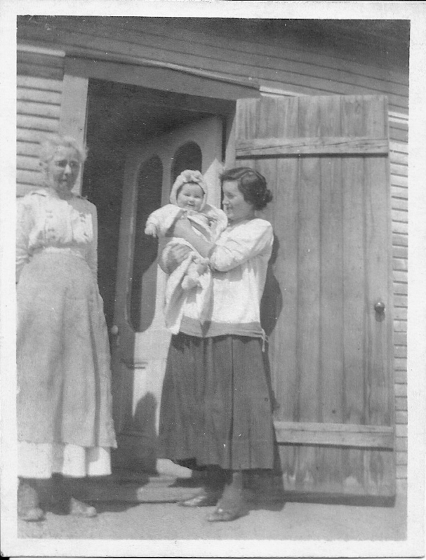 Picture of Ruby Gonya Monty holding her infant daughter Joyce. Standing on the left hand side of the picture is Ruby's Mother-in-law Emma Craft Monty. 